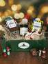 Mini Merry Crate featuring Solmate holiday socks, a warm and cozy candle, butter pecan shortbread cookies, and two cranberry vanilla cocktail/mocktail mix packets, beautifully packaged with festive holiday décor.